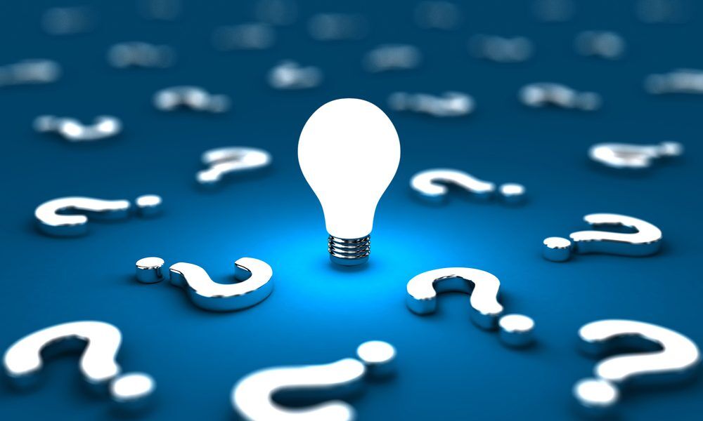 Lightbulb surrounded by question marks